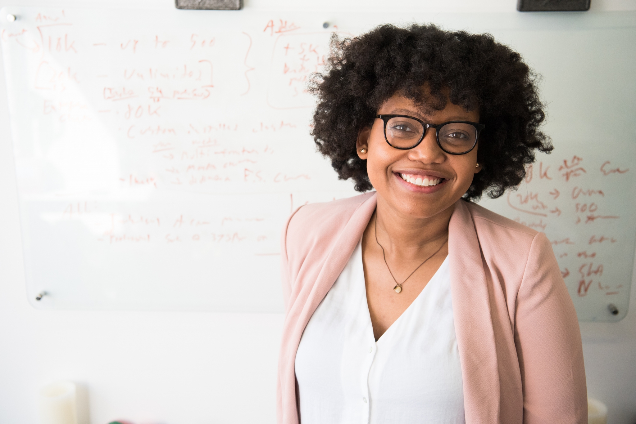 Smiling woman in front of a whiteboard