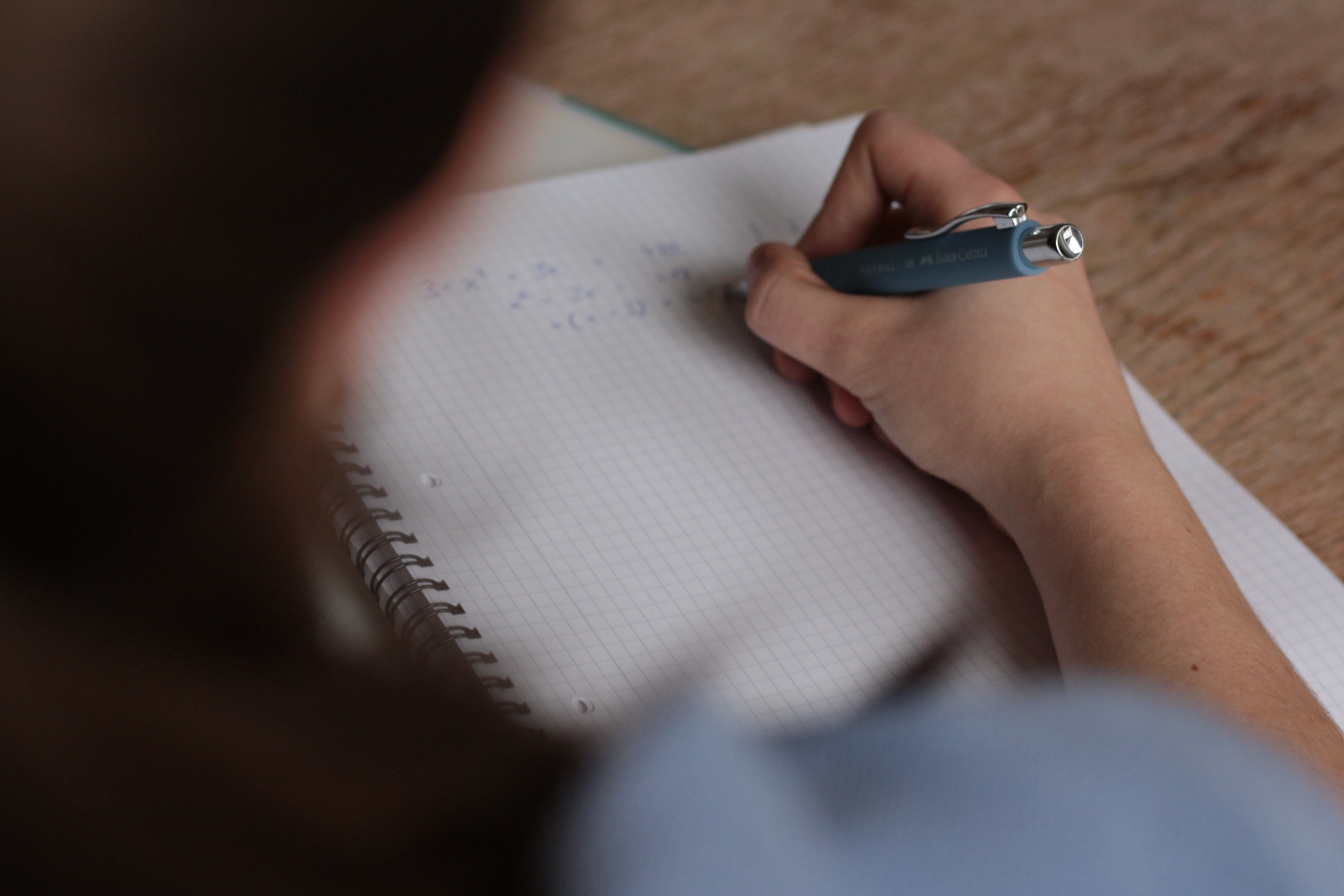 Student writing on graph paper