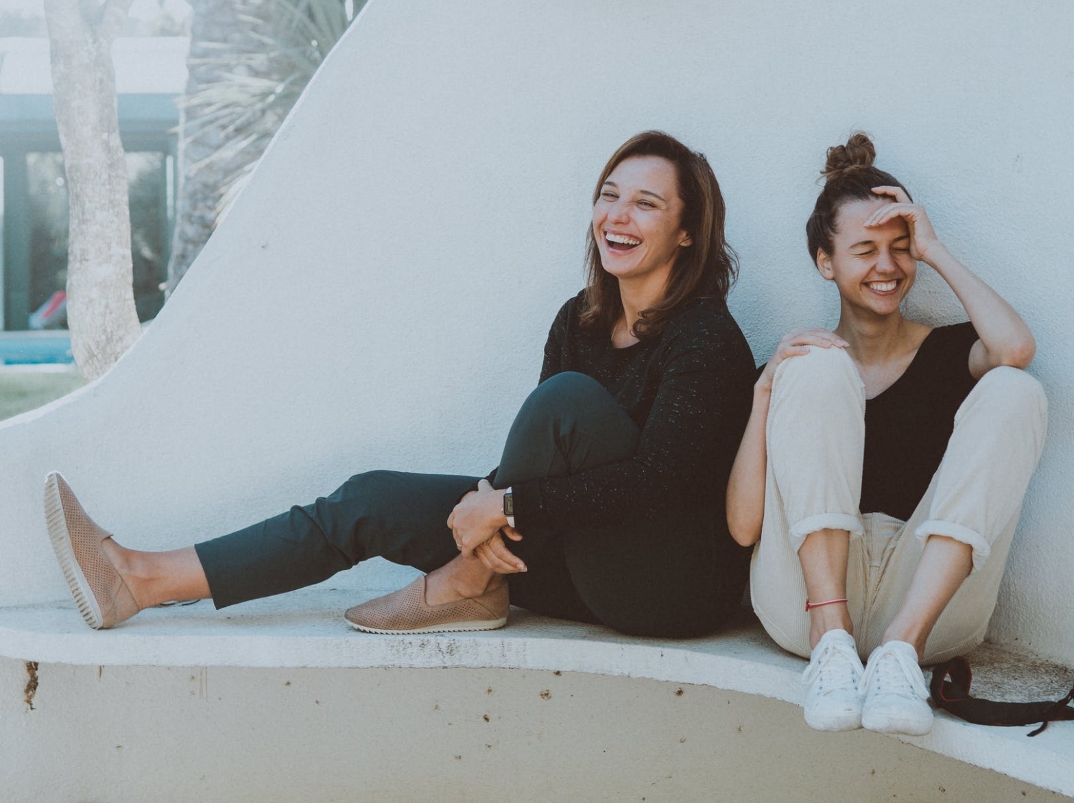 Two women laughing outdoors
