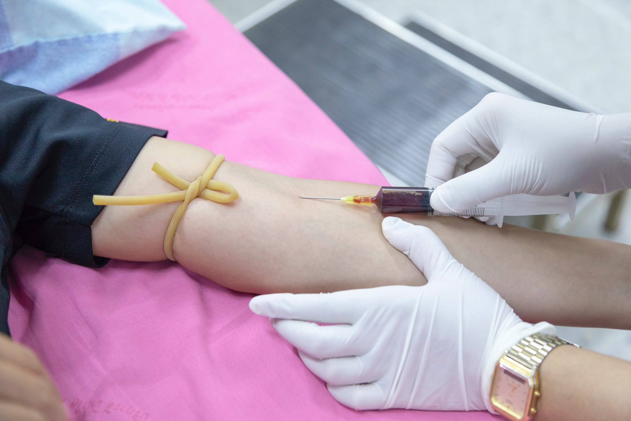 Healthcare professional drawing blood