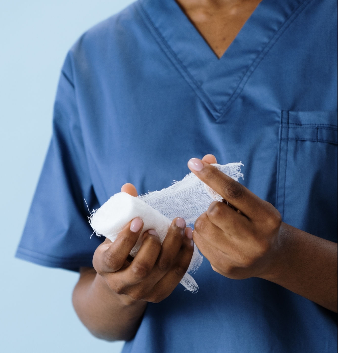 Nurse unraveling gauze