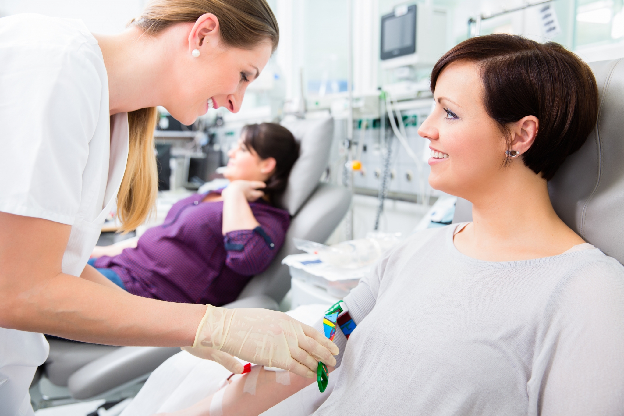 Female nurse performing blood transfusion. Female nurse performing blood transfusion.