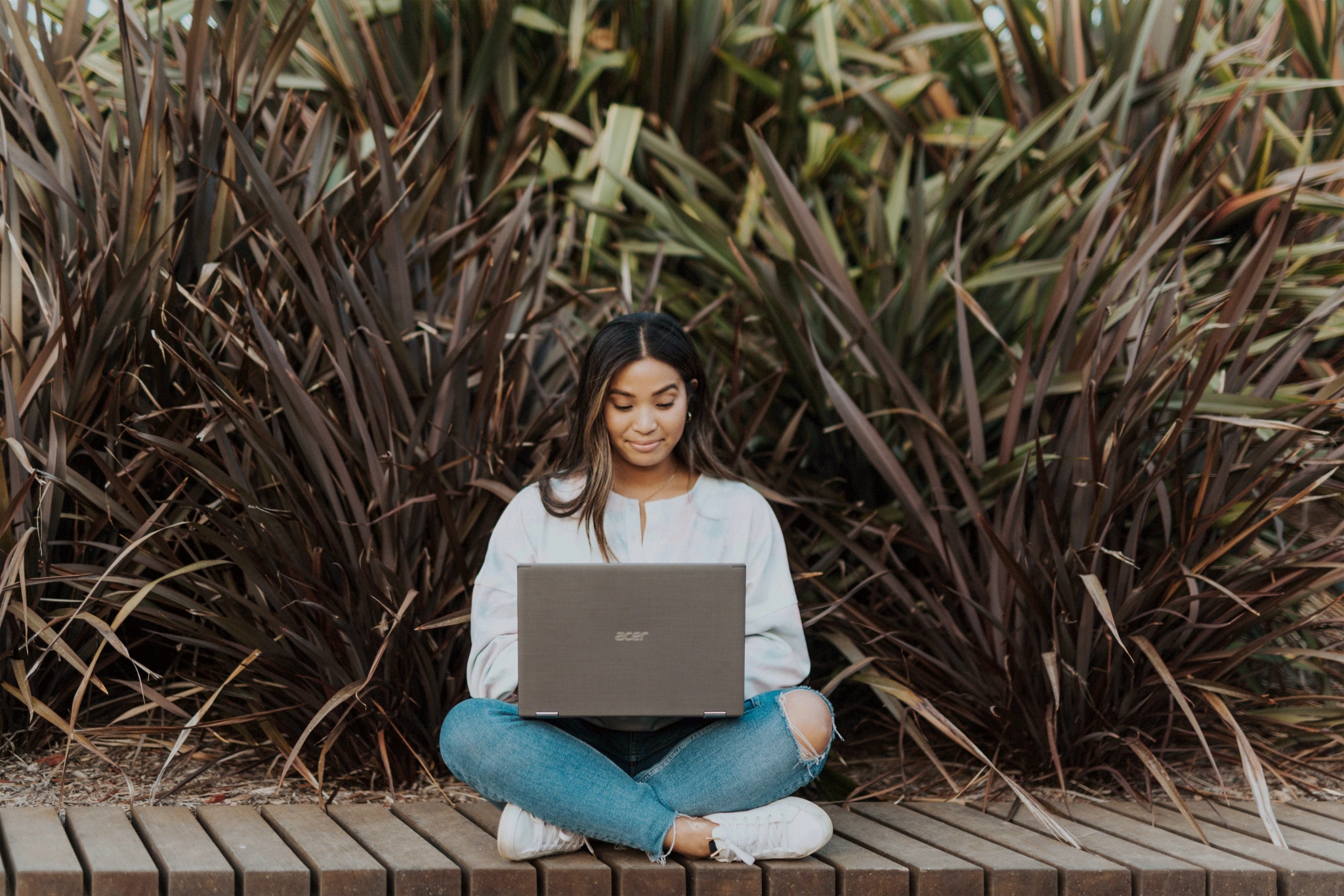 Woman outside on a laptop Woman outside on a laptop.