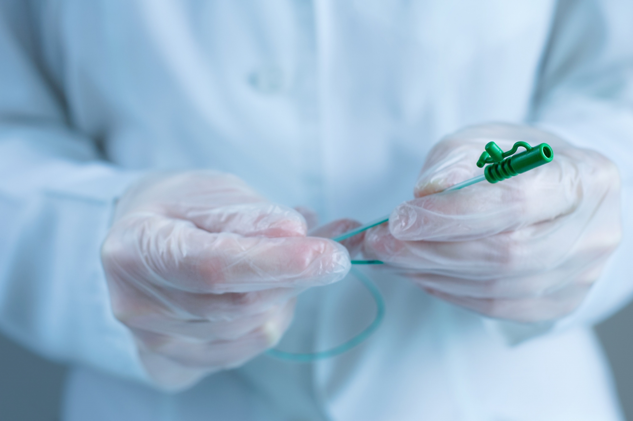 Close up of a catheter in gloved hands