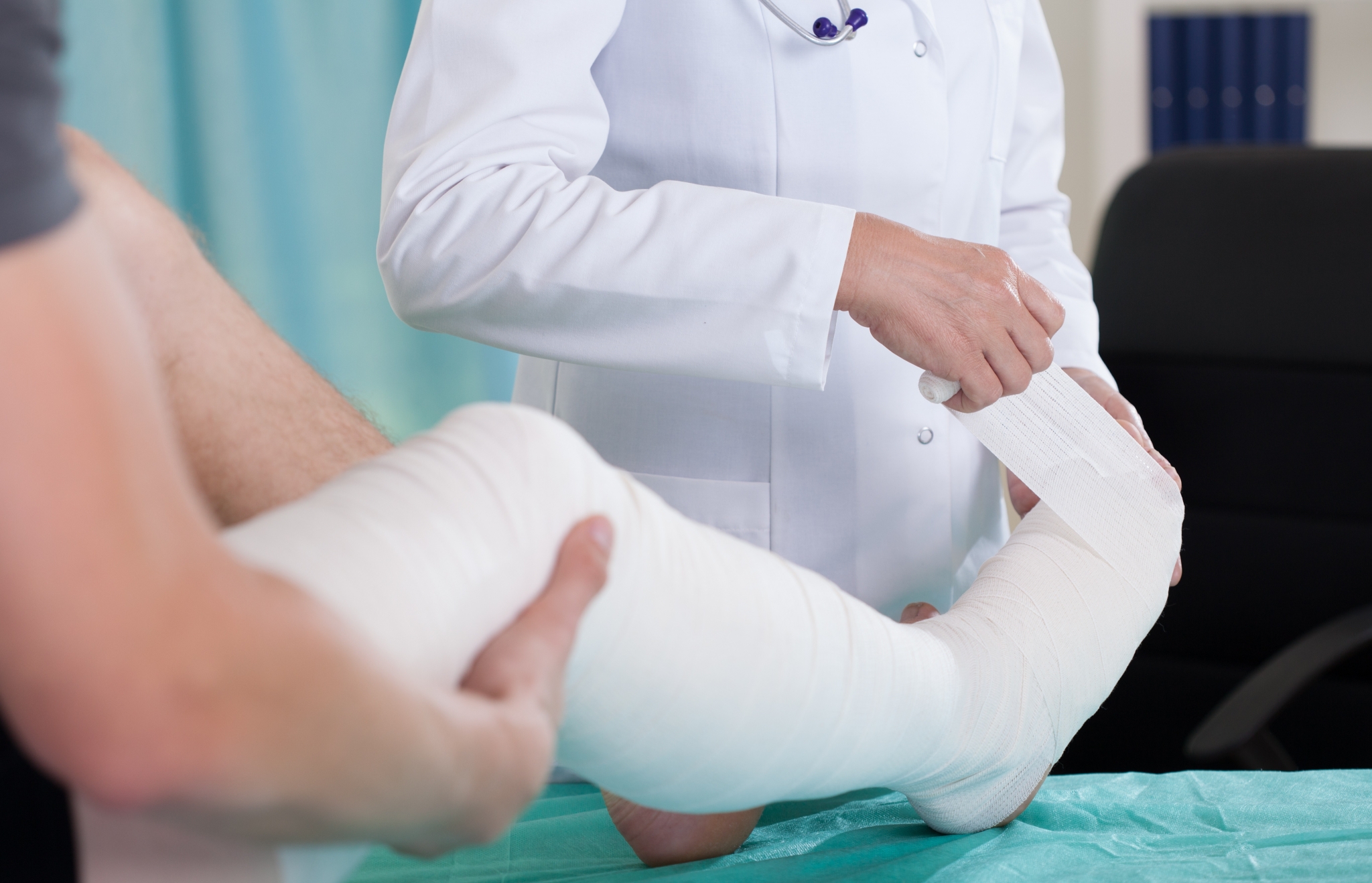 Nurse wrapping a patient's foot with a bandage