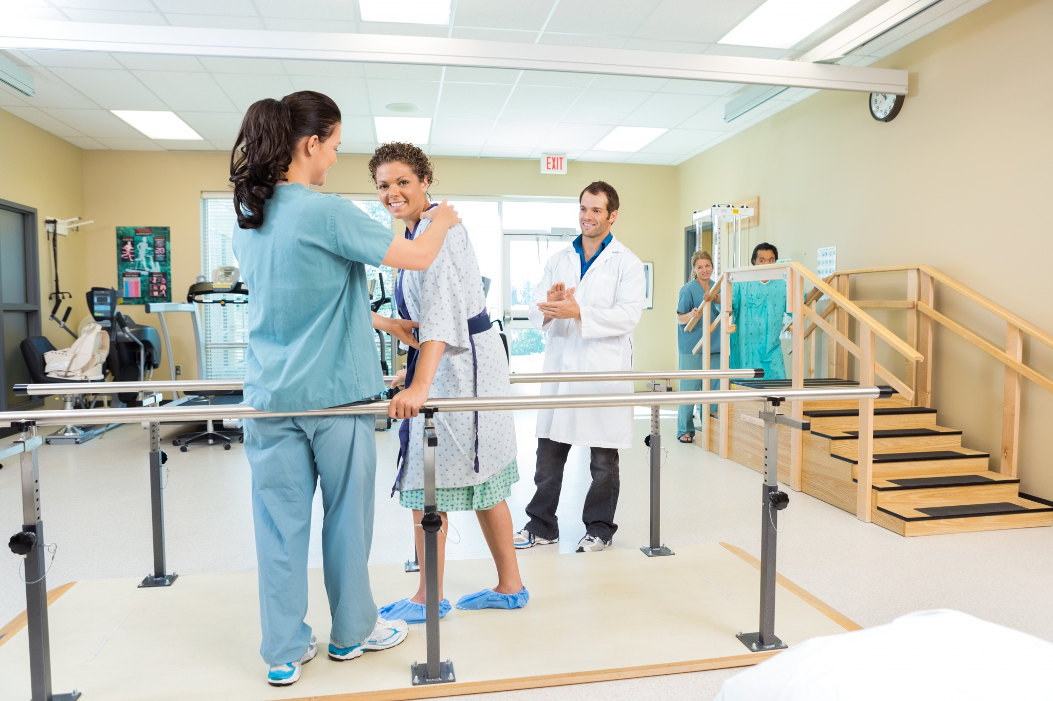 Physical Therapist Assistant helping a patient walk