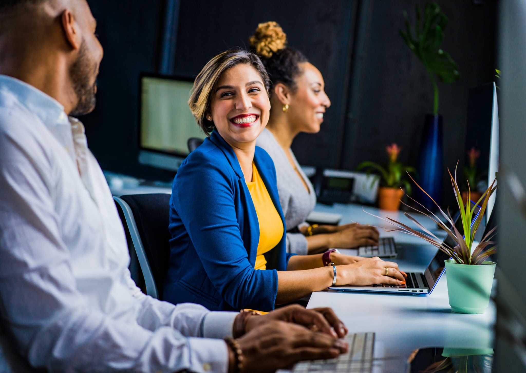Smiling female professional on a laptop