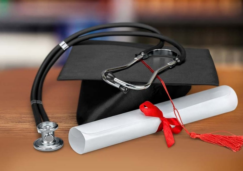 Graduate cap, diploma, and stethoscope