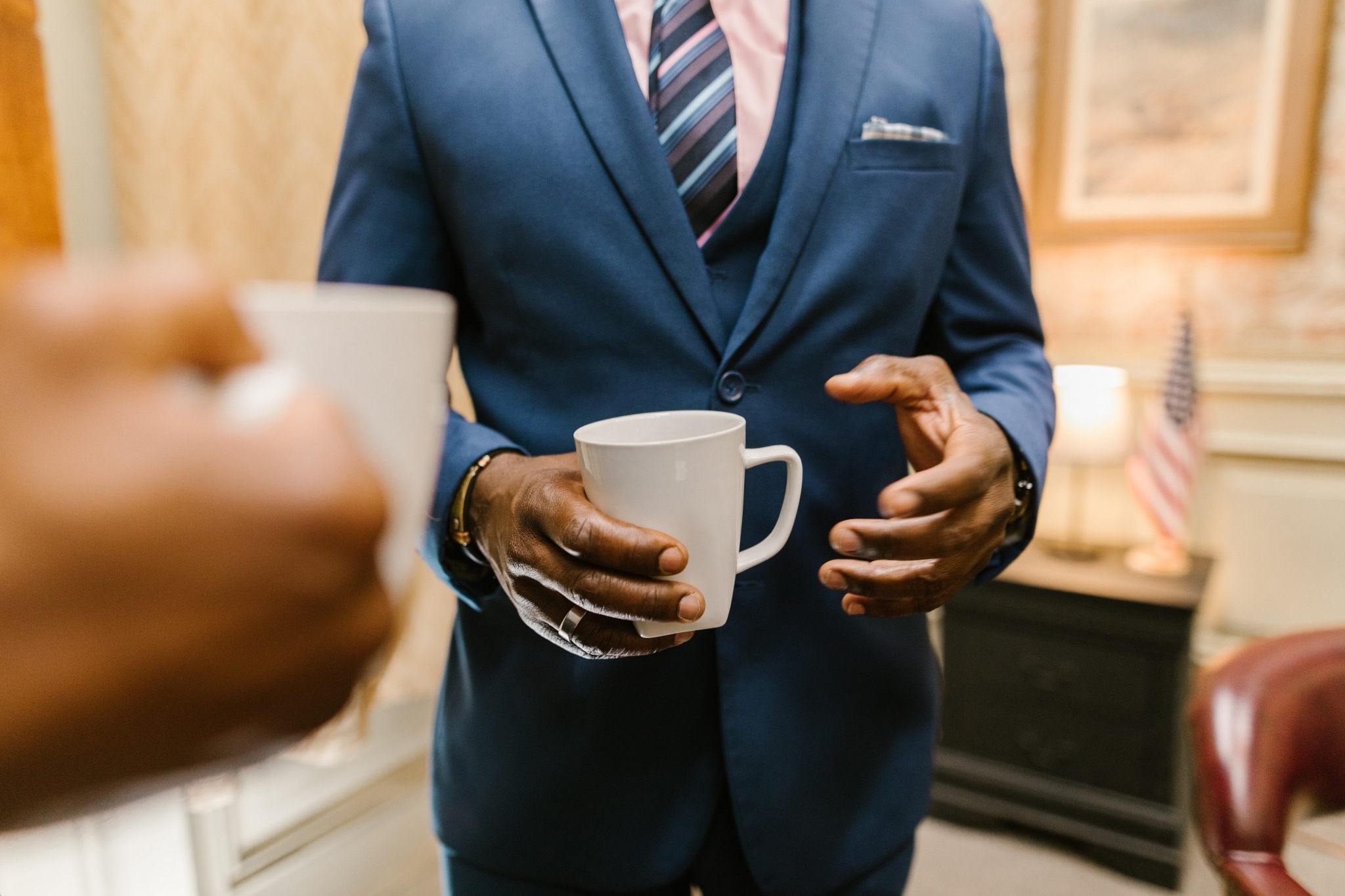 Close up of a lawyer holding a white mug