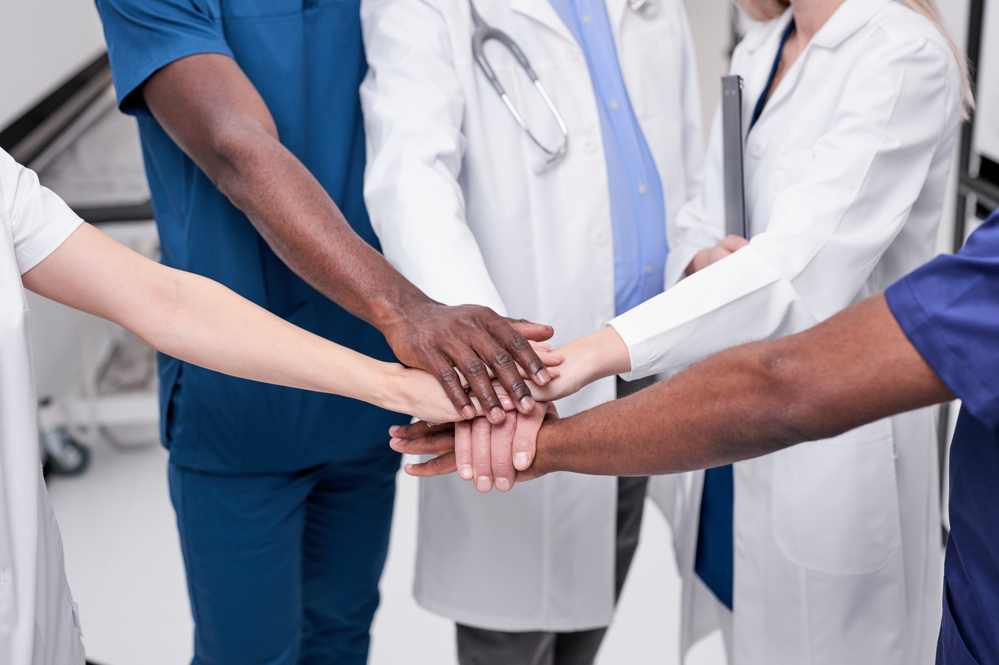 Medical professionals touching hands as a symbol of teamwork