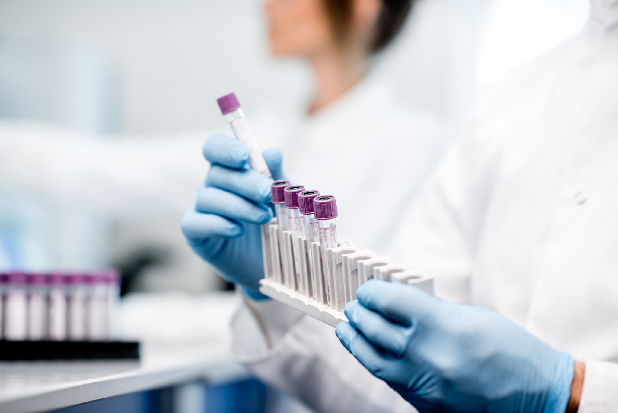A lab assistant assembling test tubes
