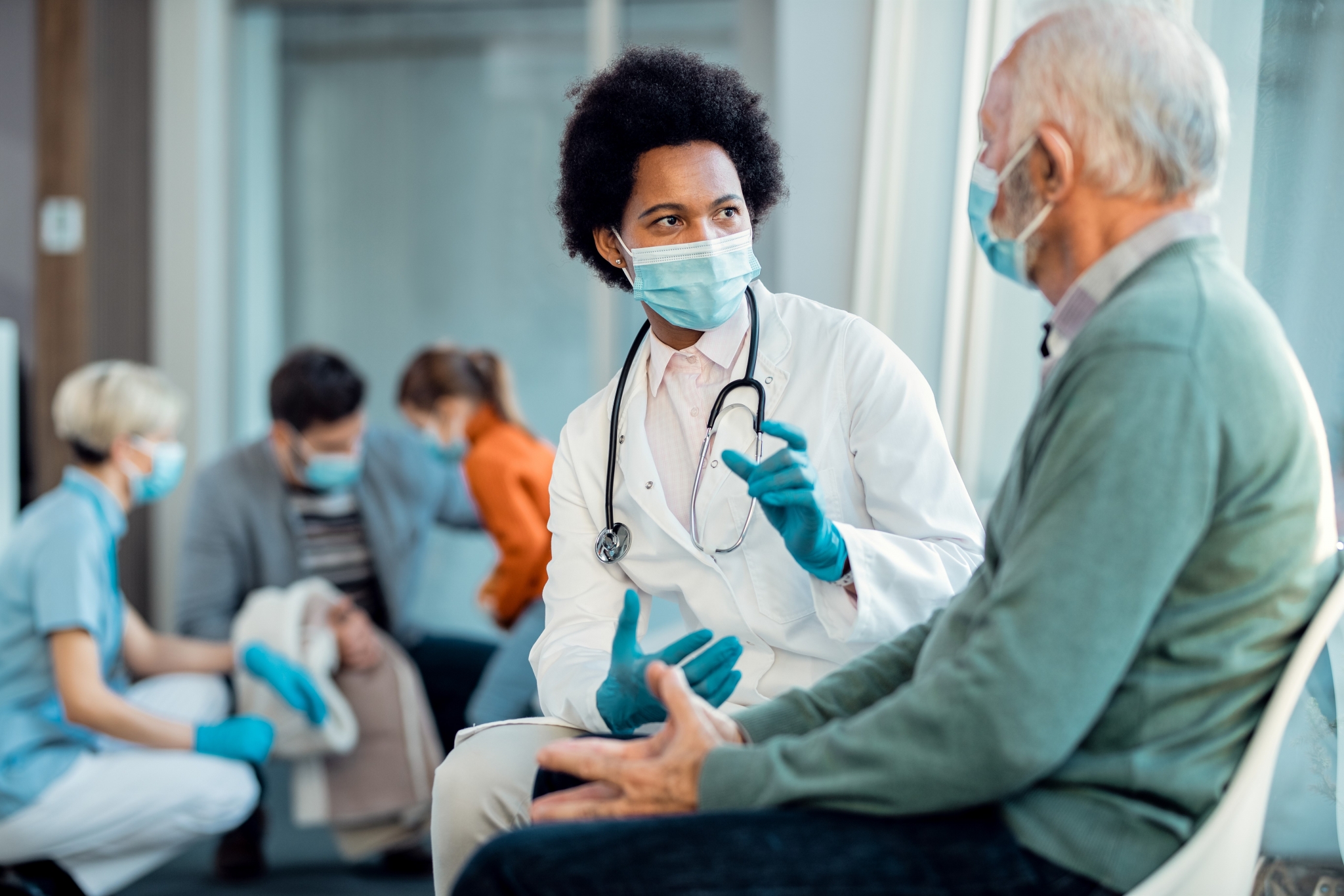 African-American doctor with an elderly patient