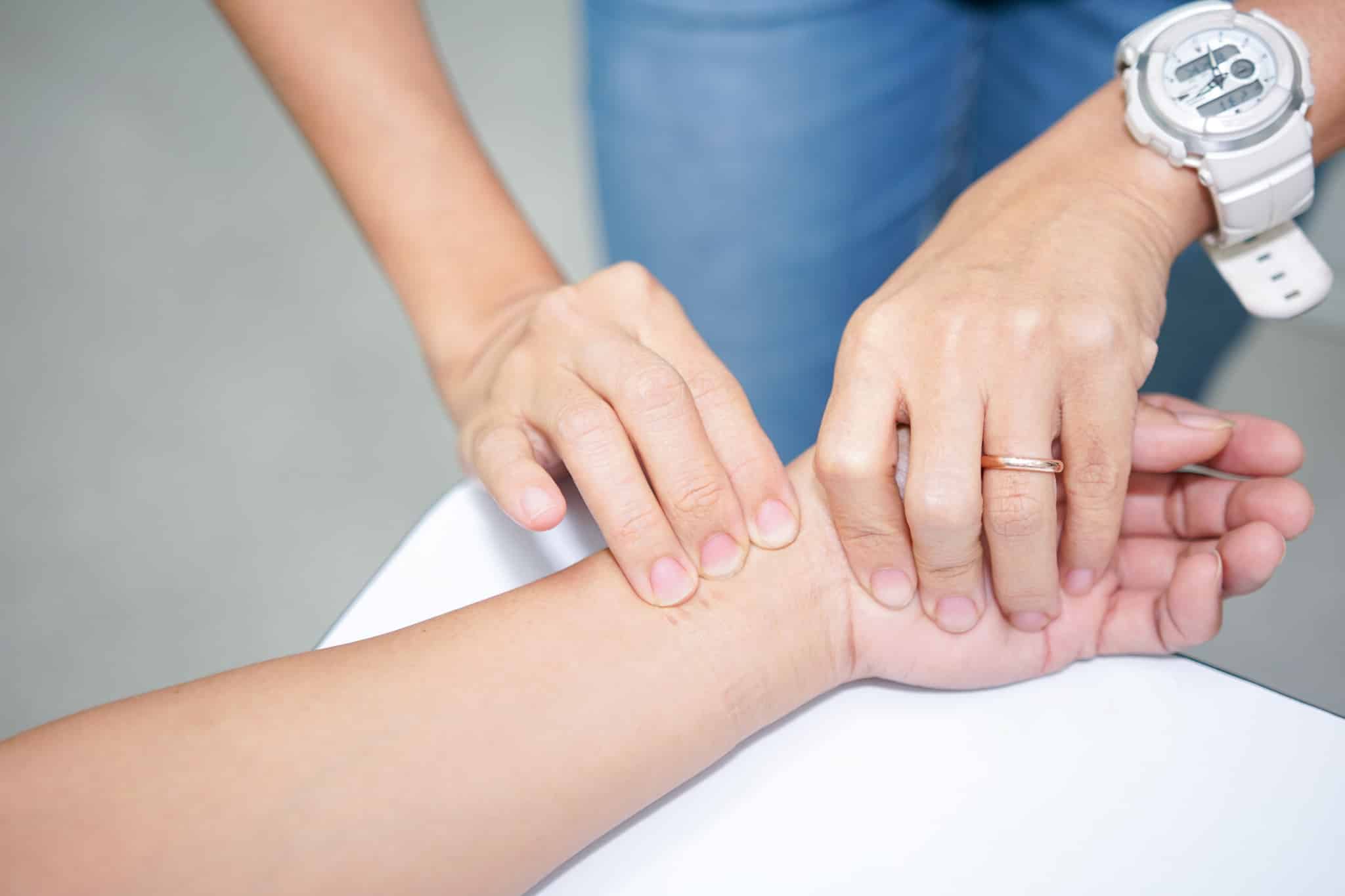Hand feeling for a pulse.