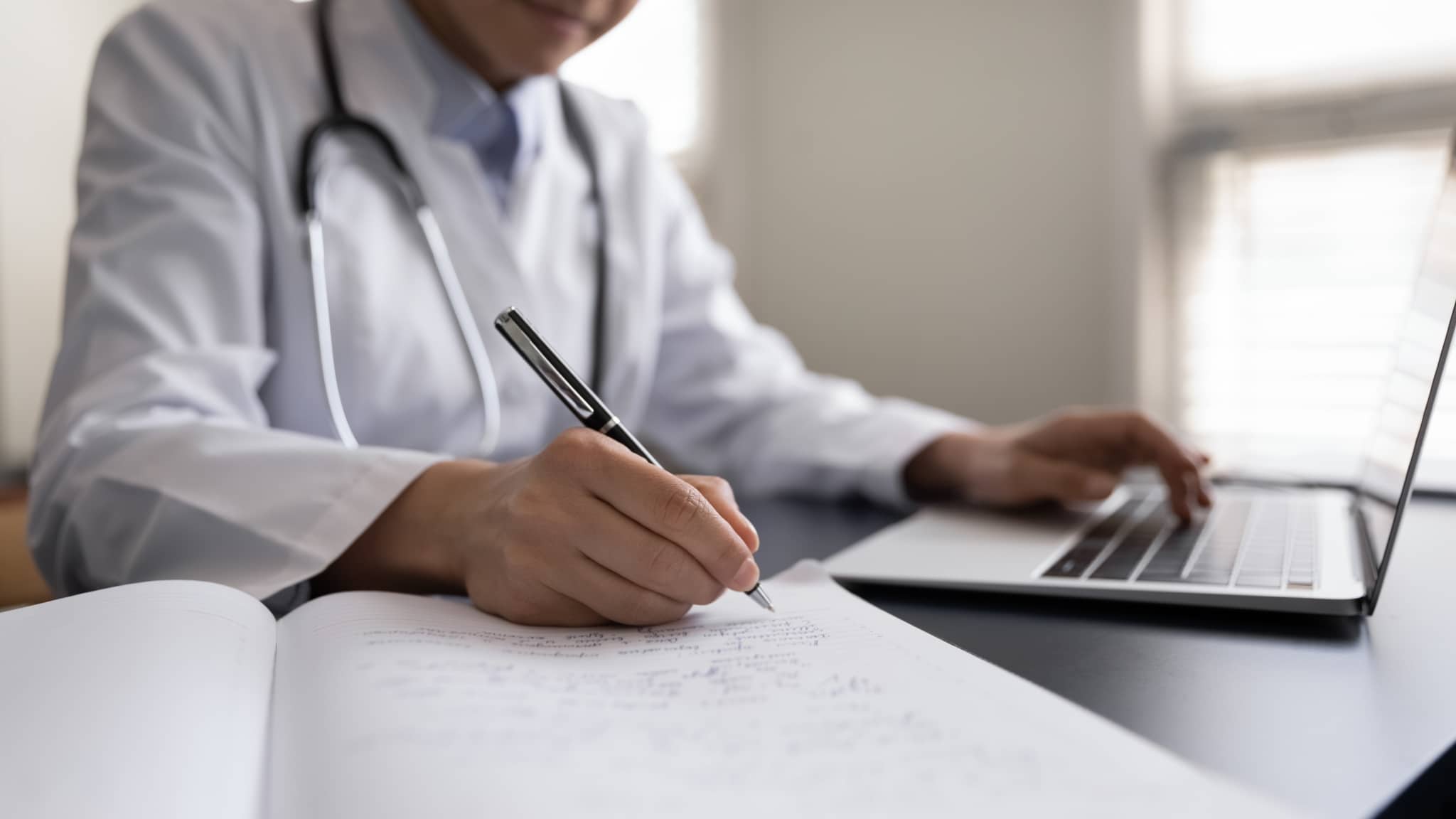Close up of a medical professional on a laptop
