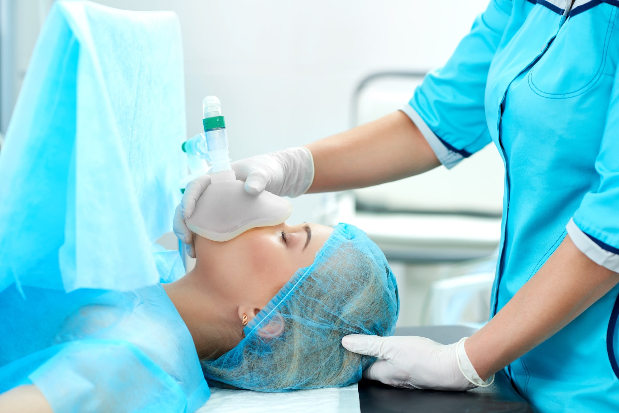 Nurse holding an oxygen mask over a patient