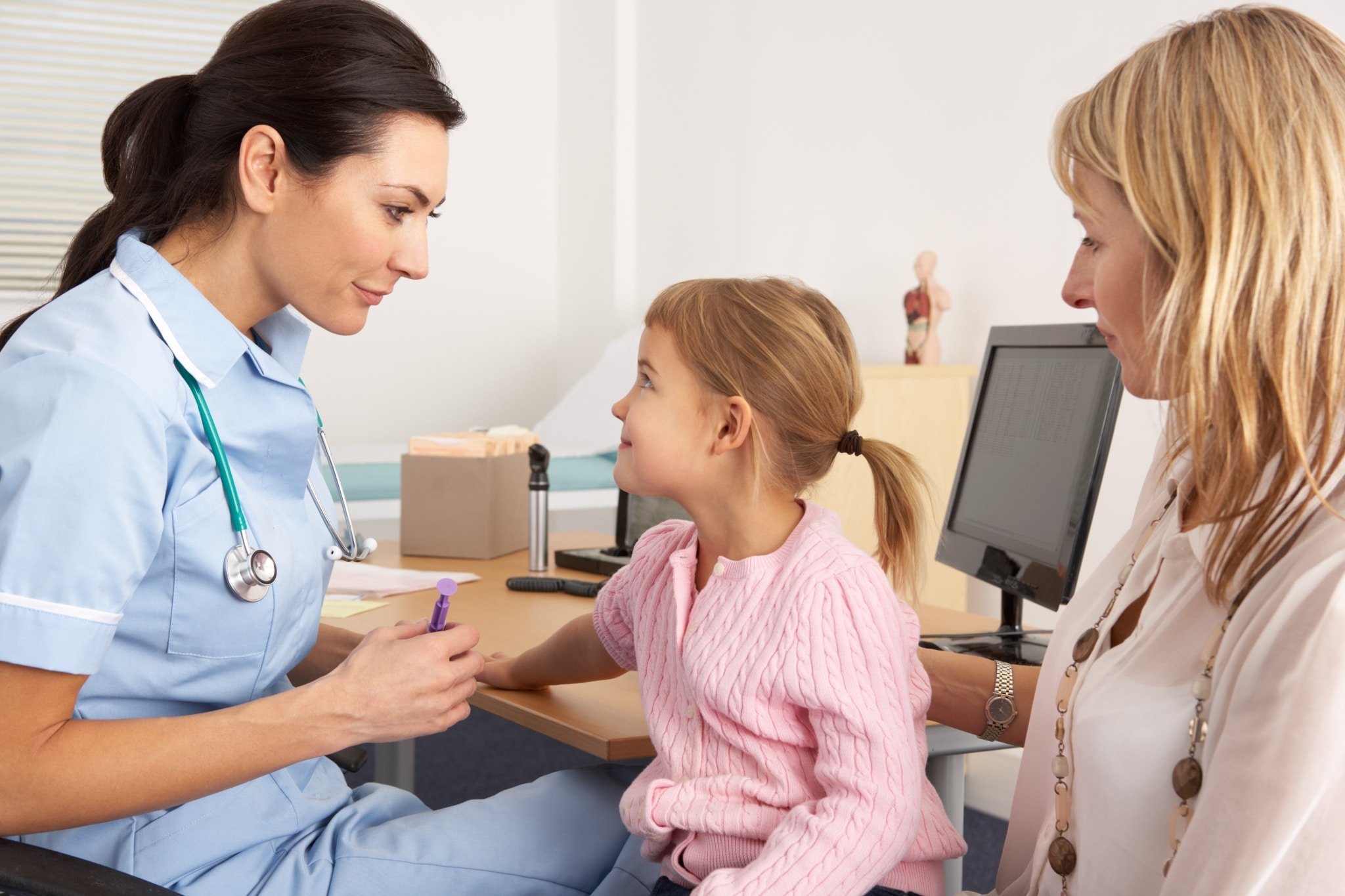 Female nurse with a young child and mother