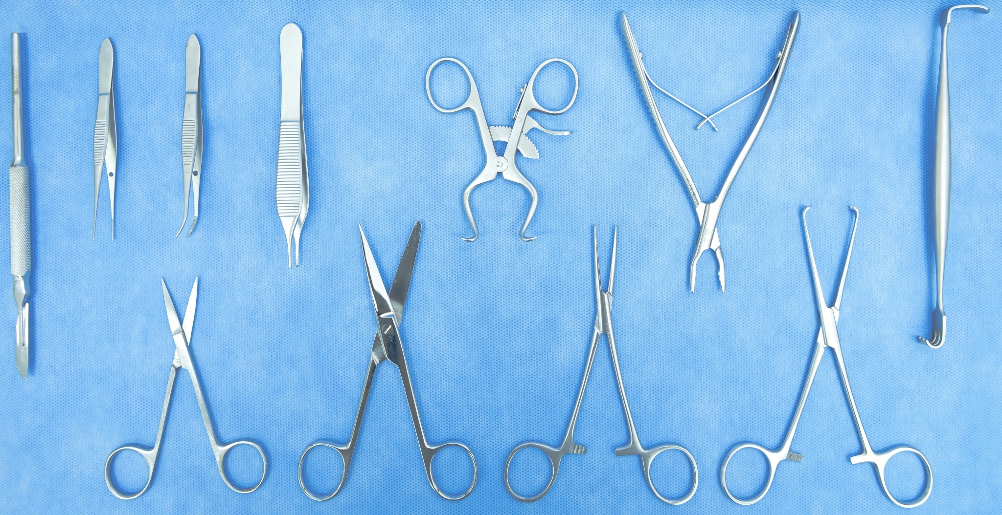 Sterilized surgical instruments on a blue sheet
