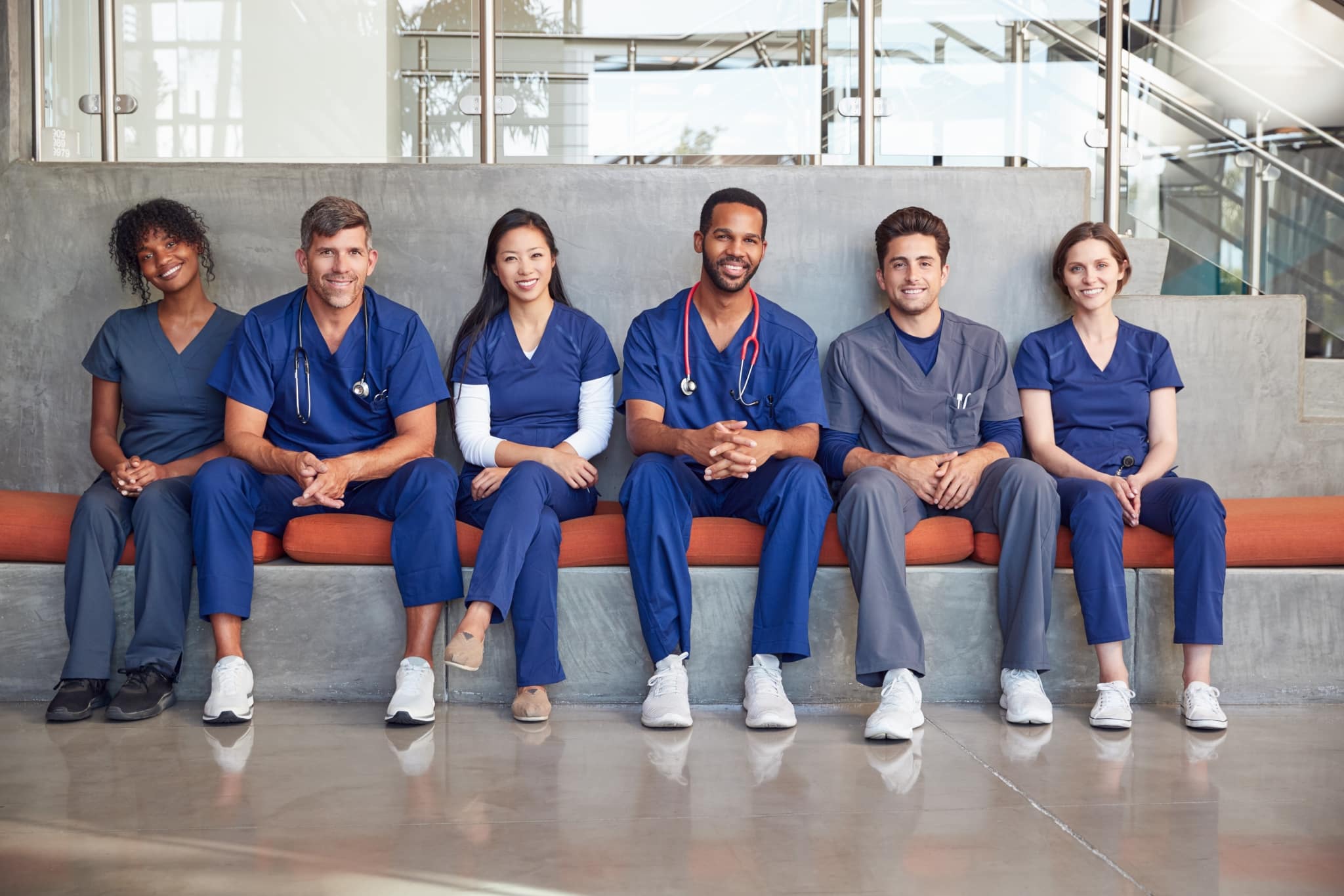 Healthcare team sitting on a hospital bench