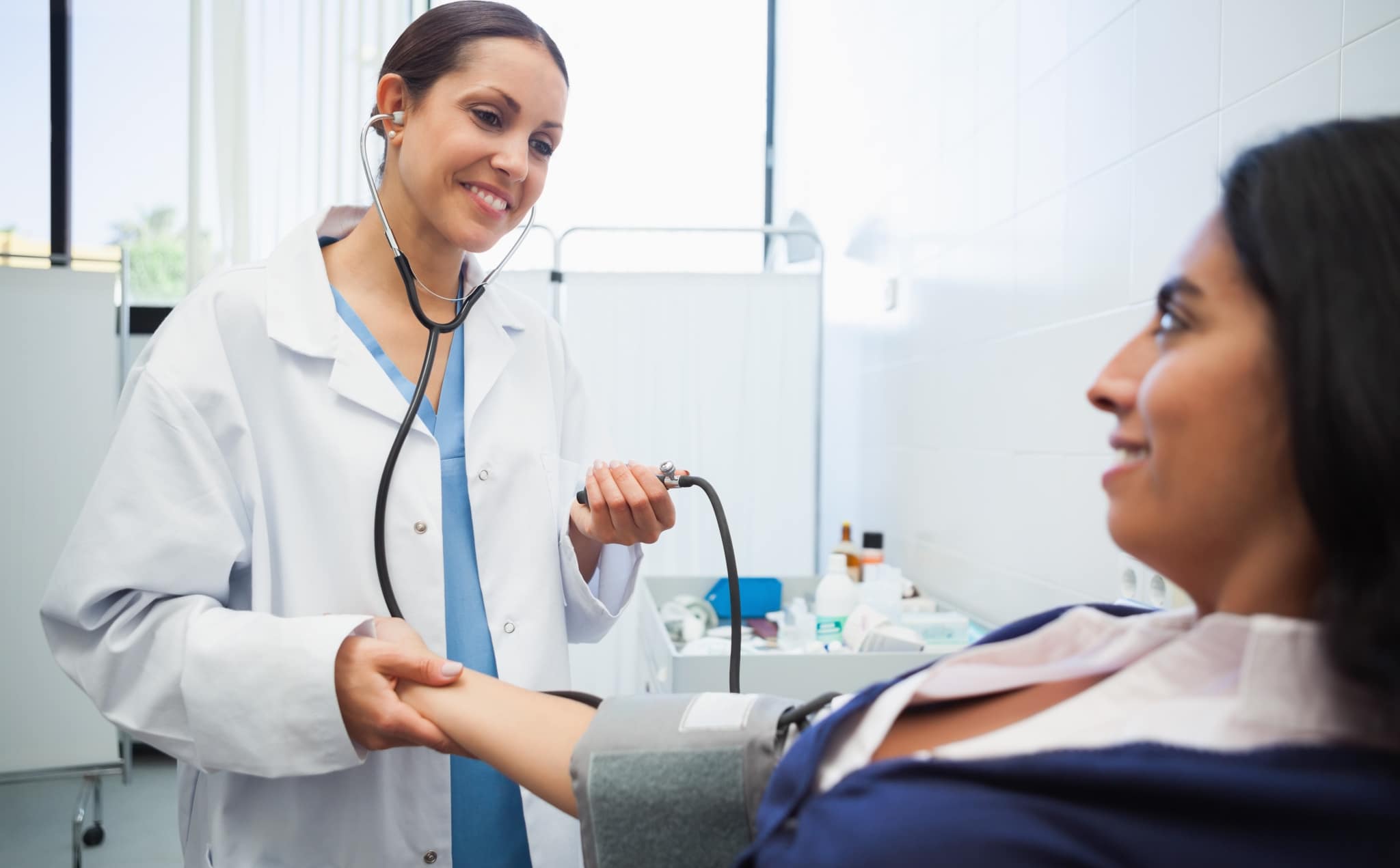 Healthcare worker measuring a patient's blood pressure