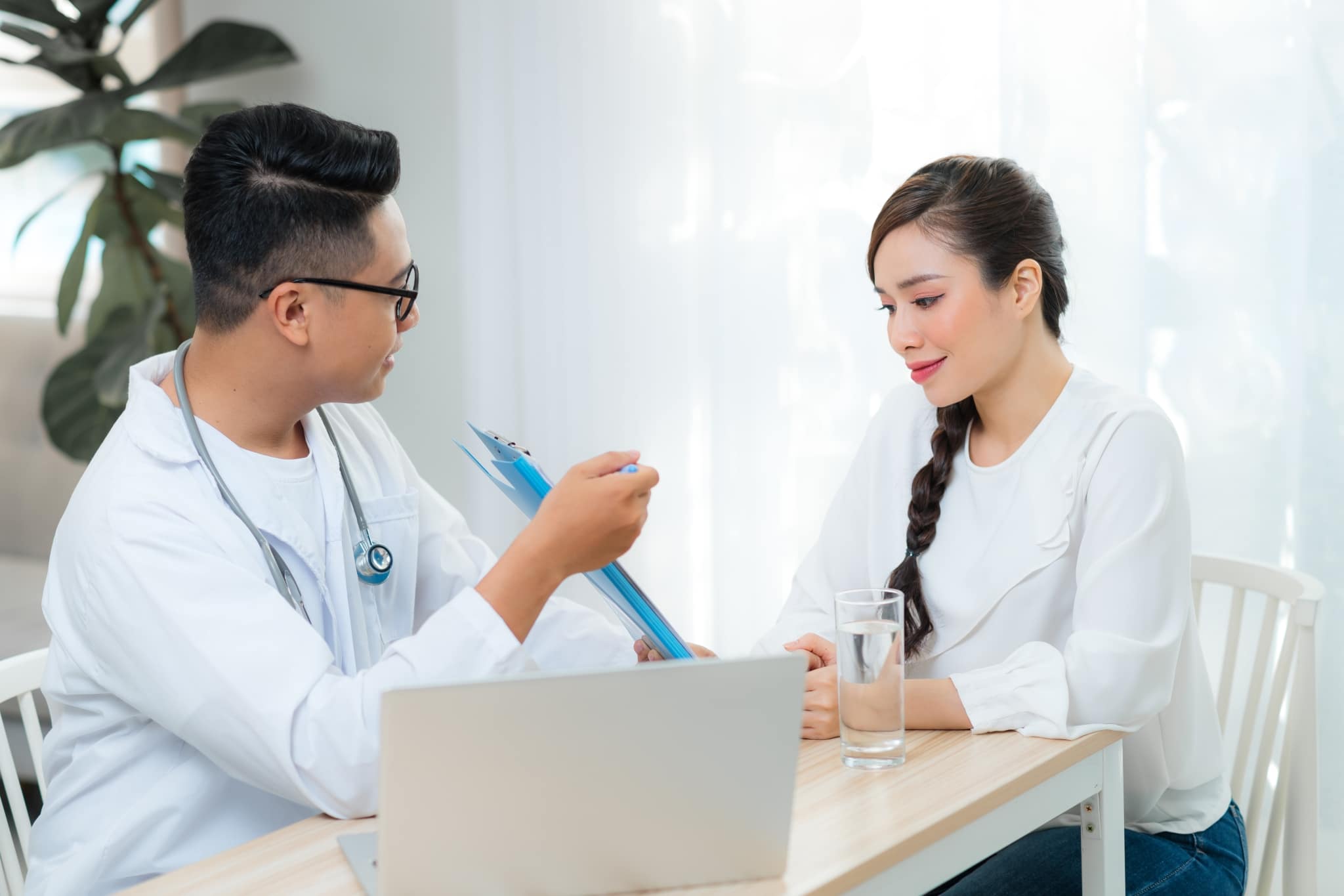 Healthcare worker assisting an Asian woman