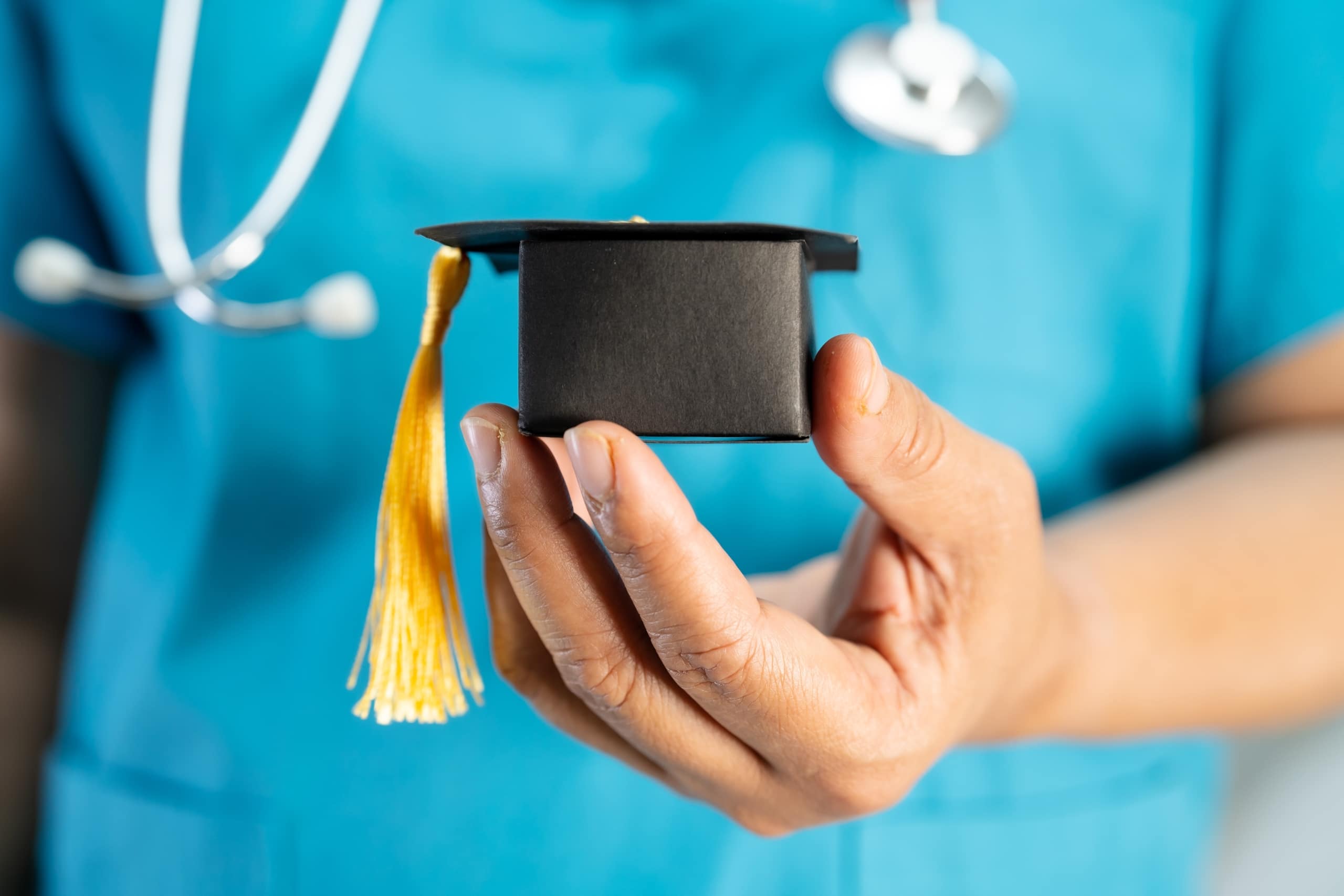 Close up of medical student with mini graduation cap