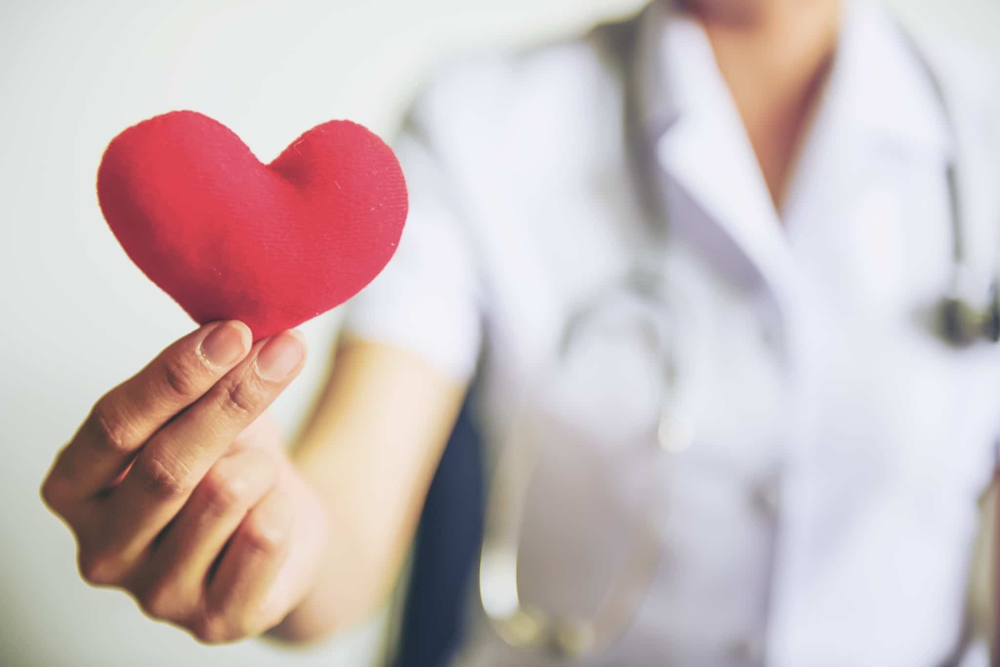 Nurse holding a red plush heart