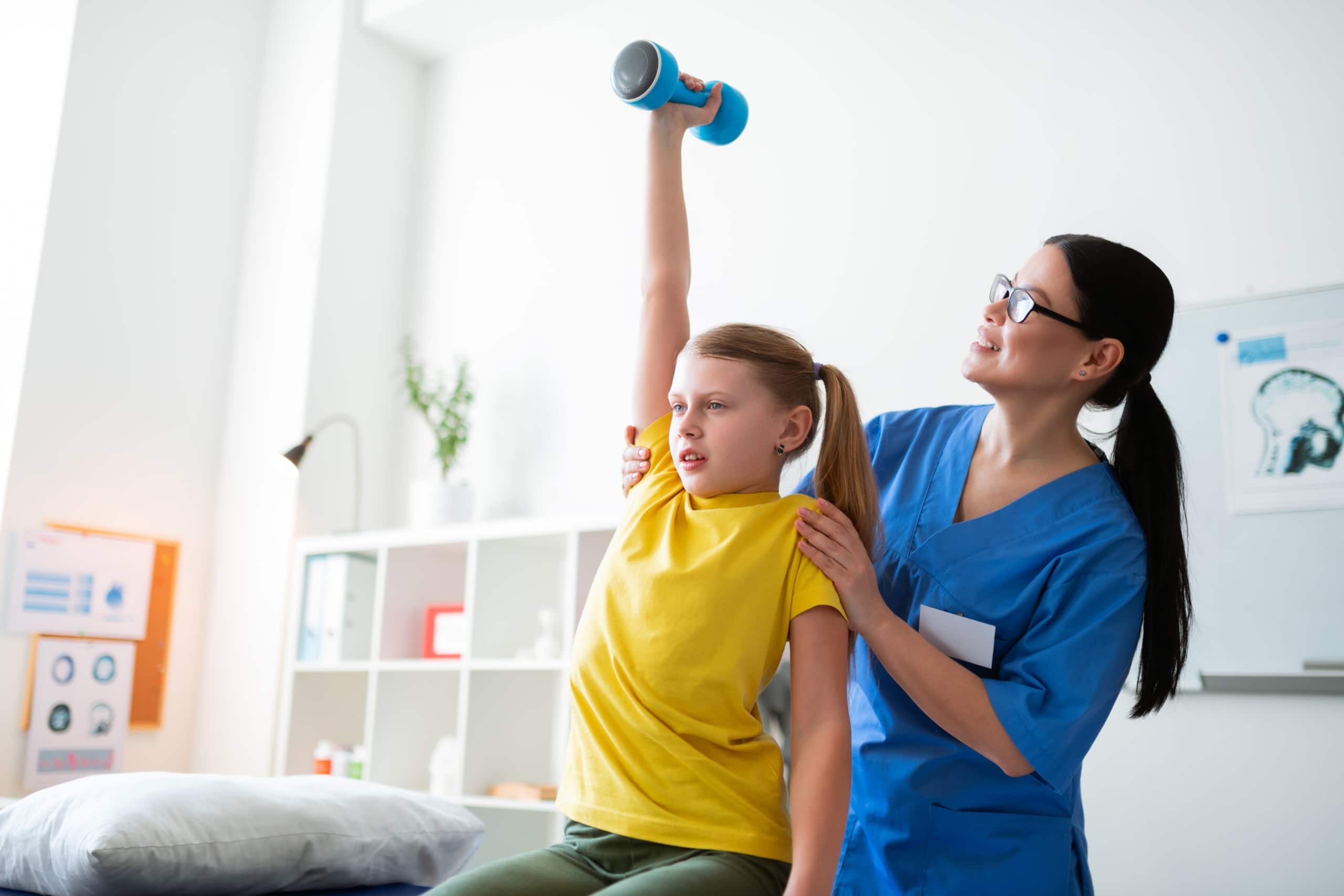Physical Therapist Assistant helping a child perform exercises