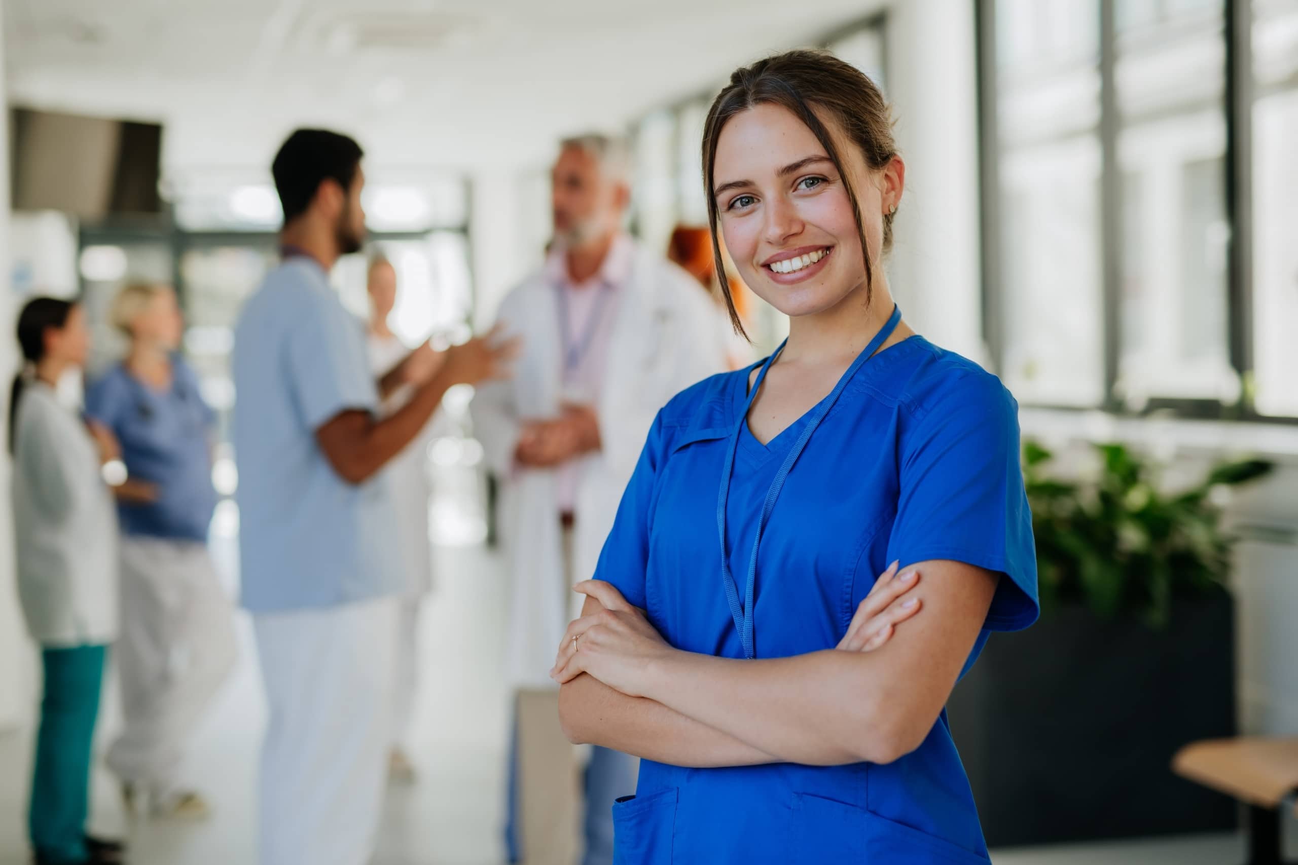 Smiling young medical professional in scrubs