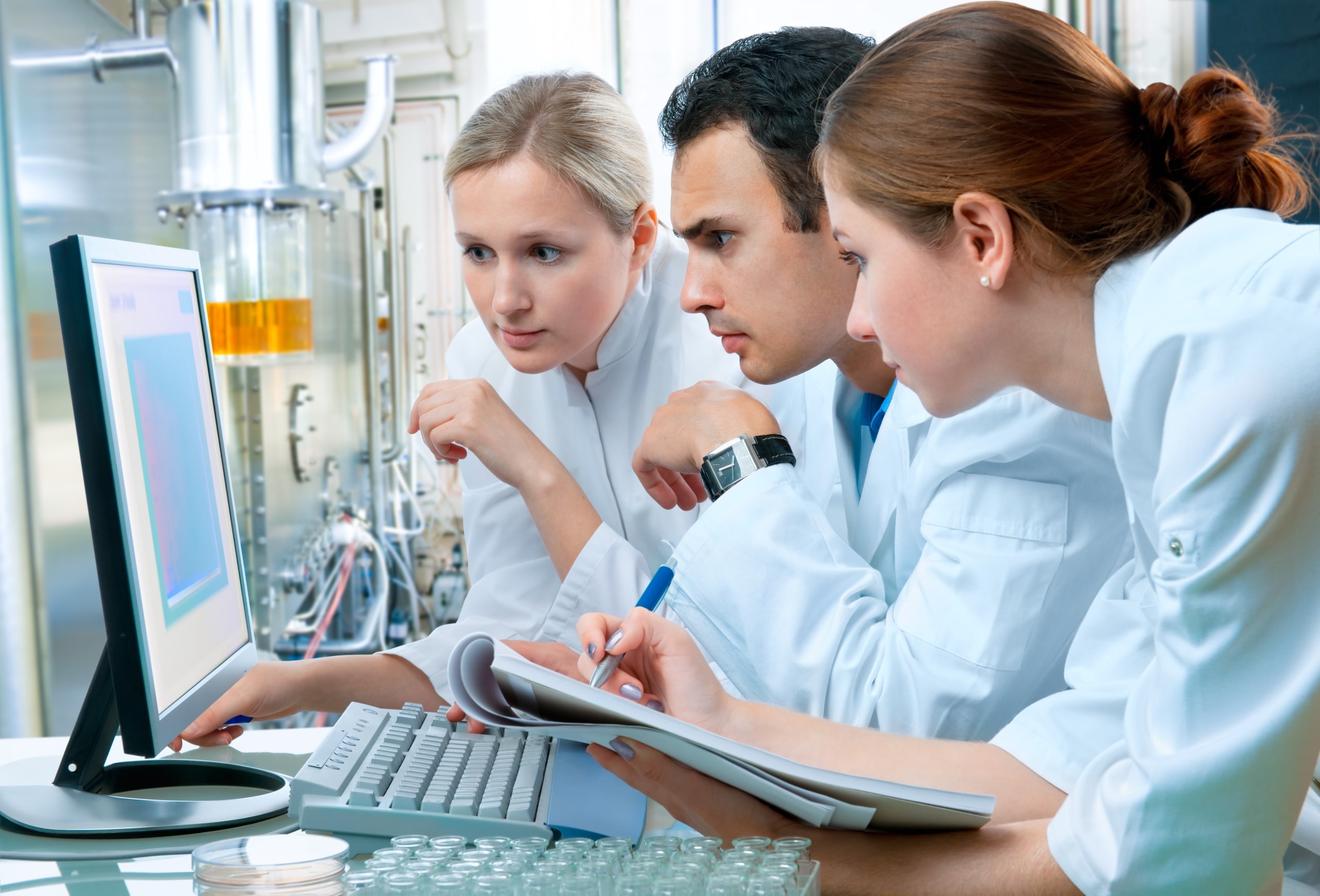 Group of medical professionals around a computer