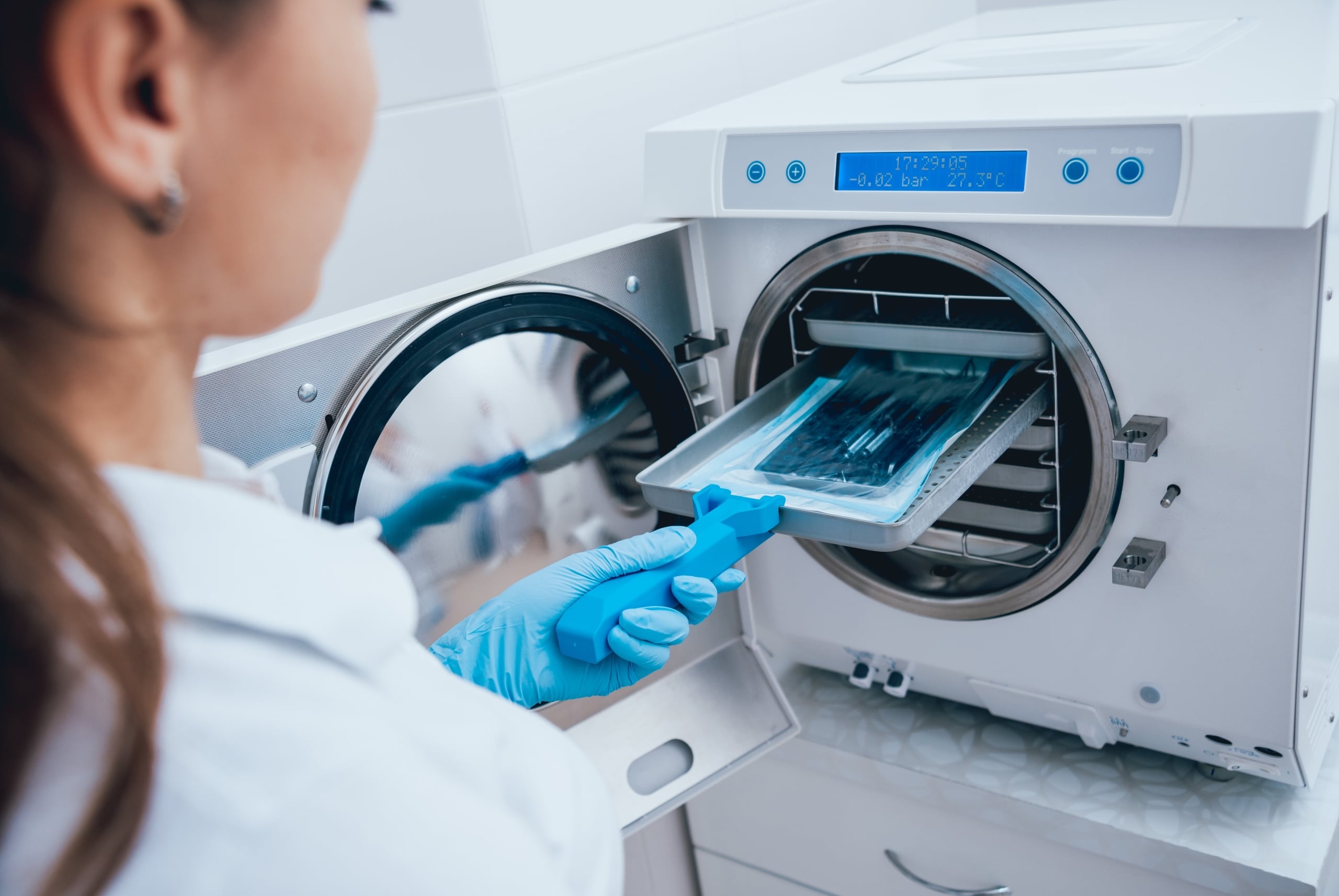 Close up of a Dental Assistant sterilizing equipment