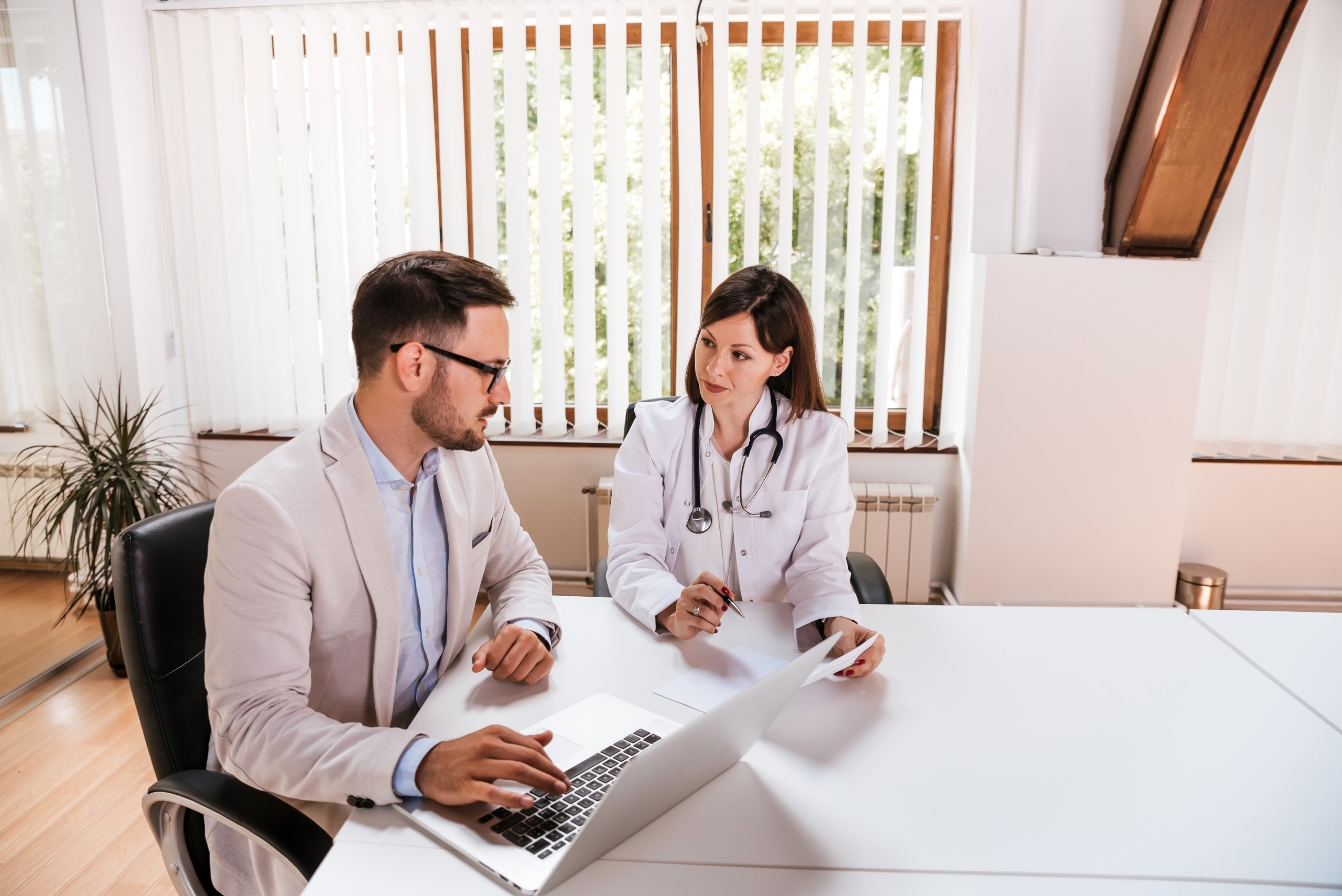 Two medical professionals in a conference room