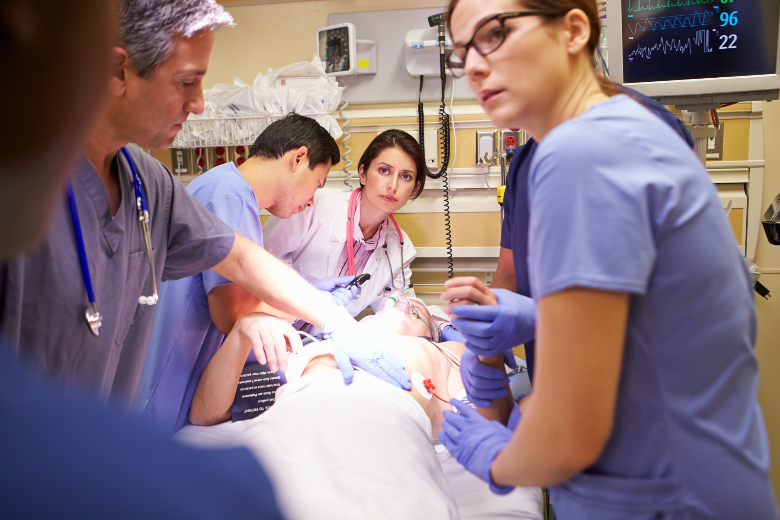Hospital team around a patient's bedside