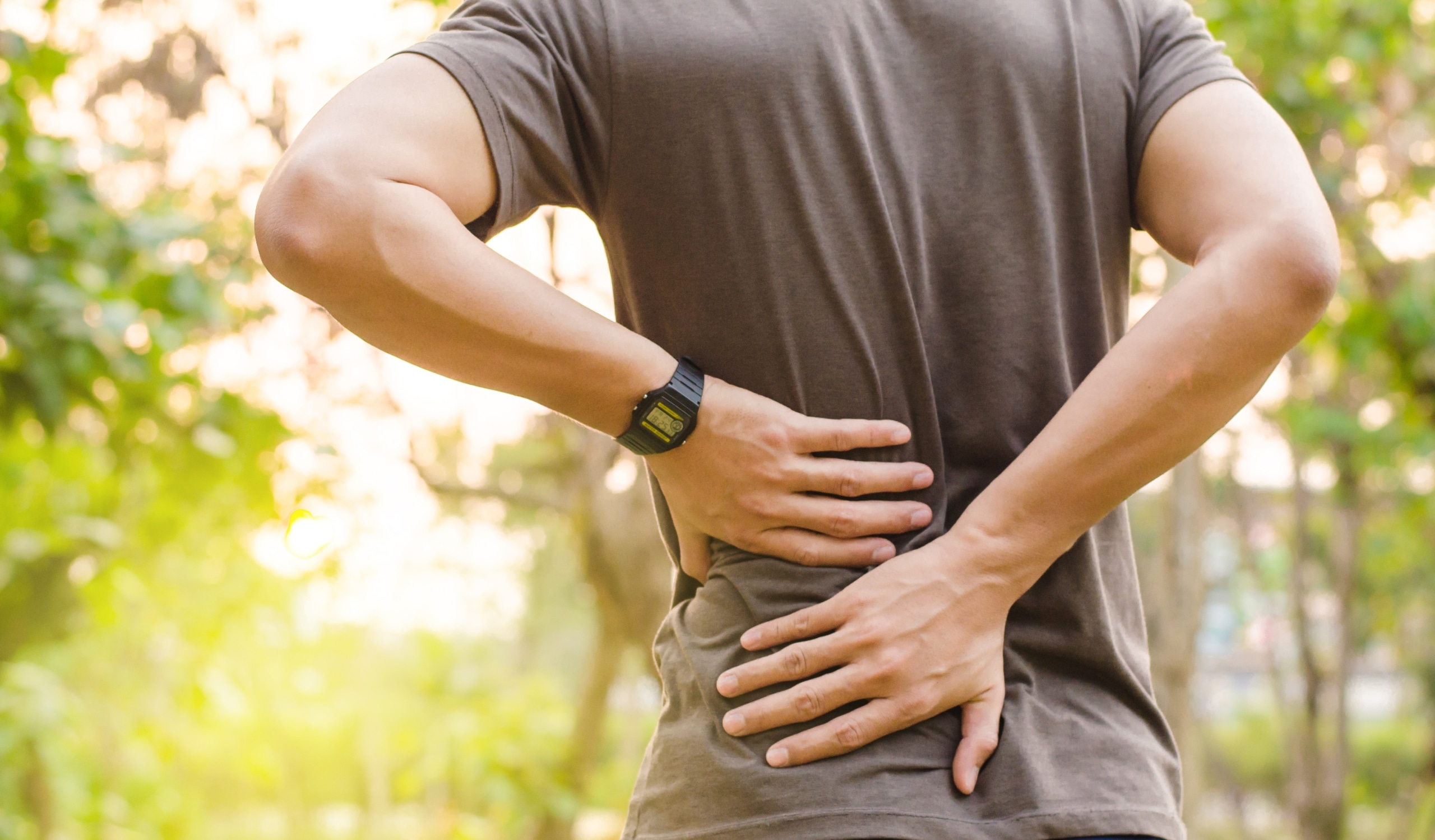 Man gripping his lower back in pain