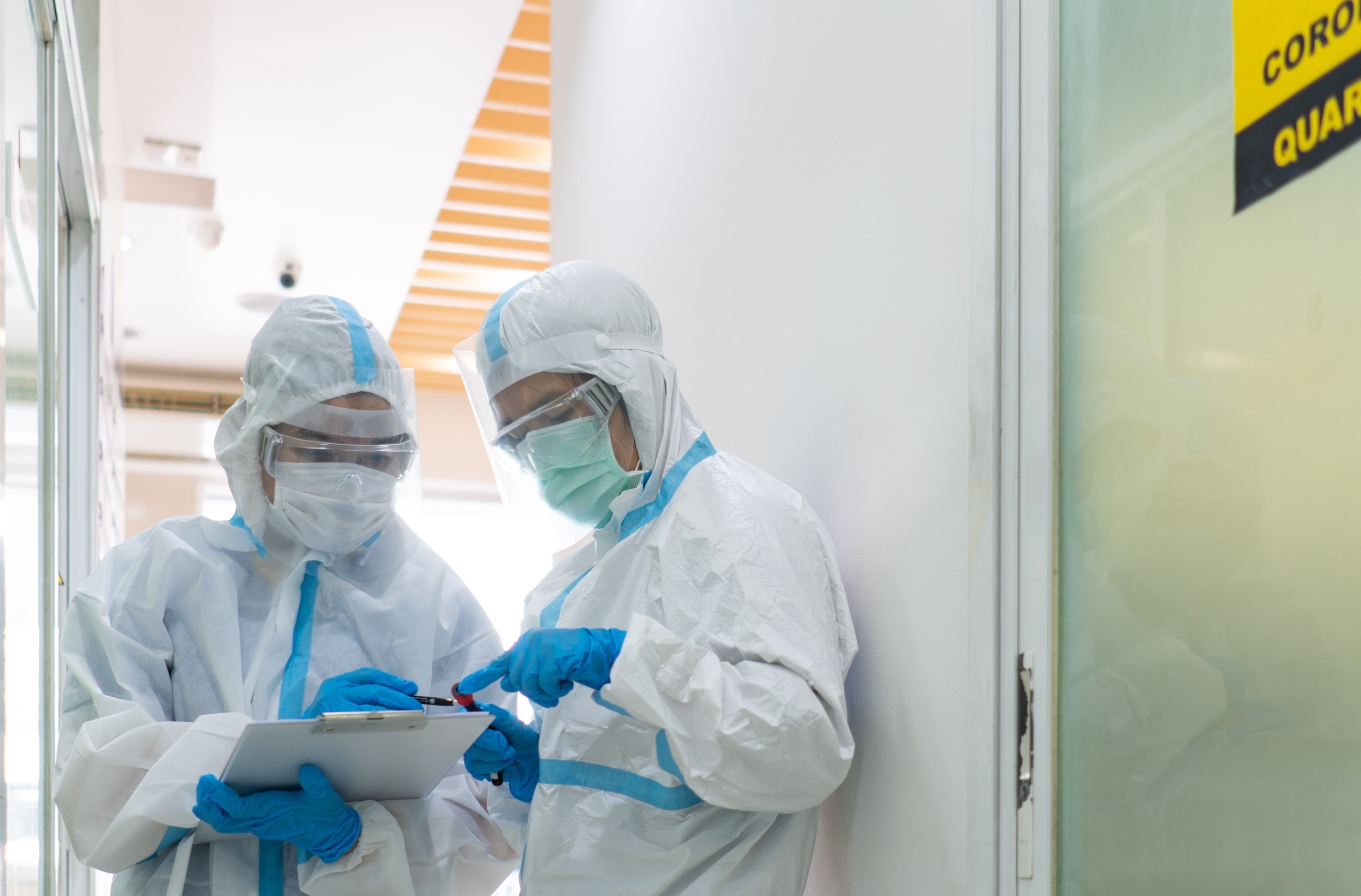 Medical professionals wearing protective gear in a quarantined zone