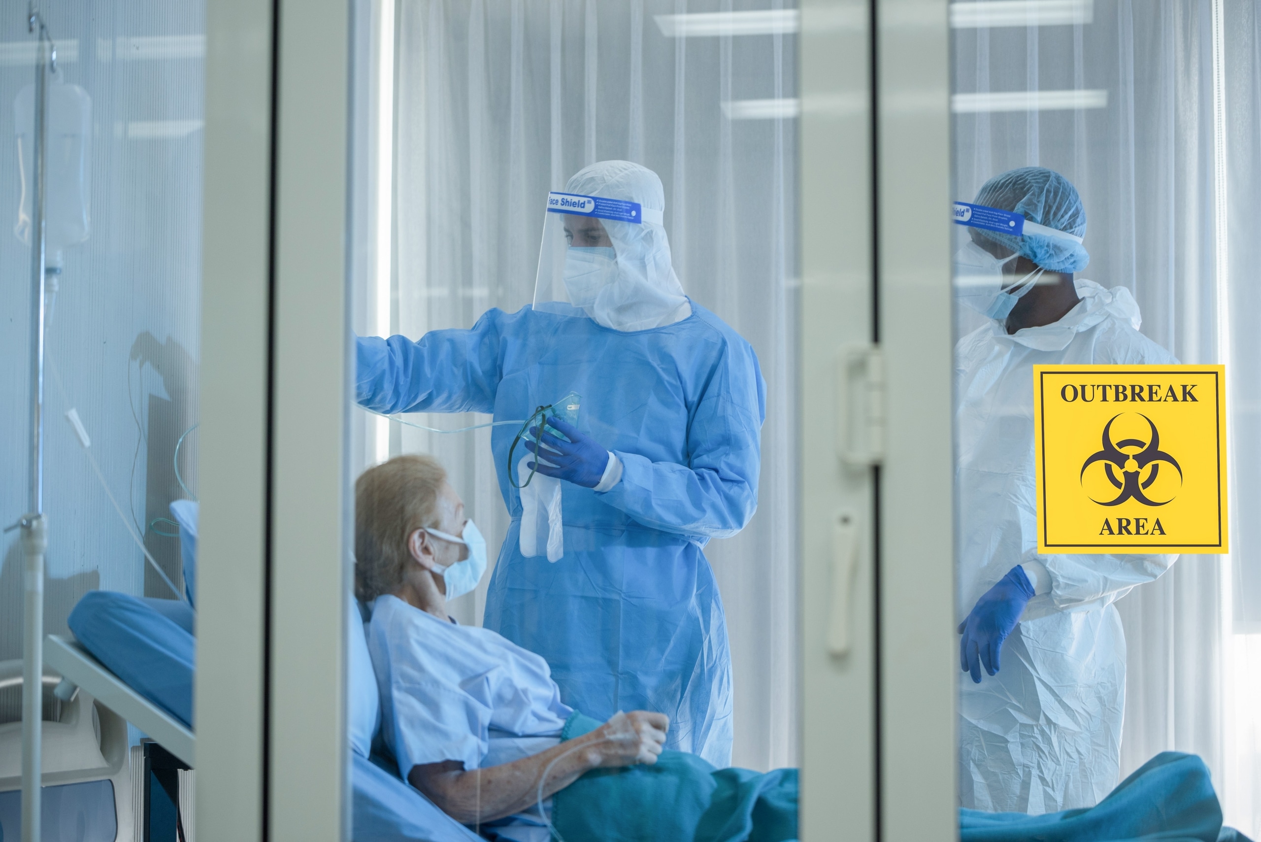 Medical professionals wearing protective gear in an outbreak area