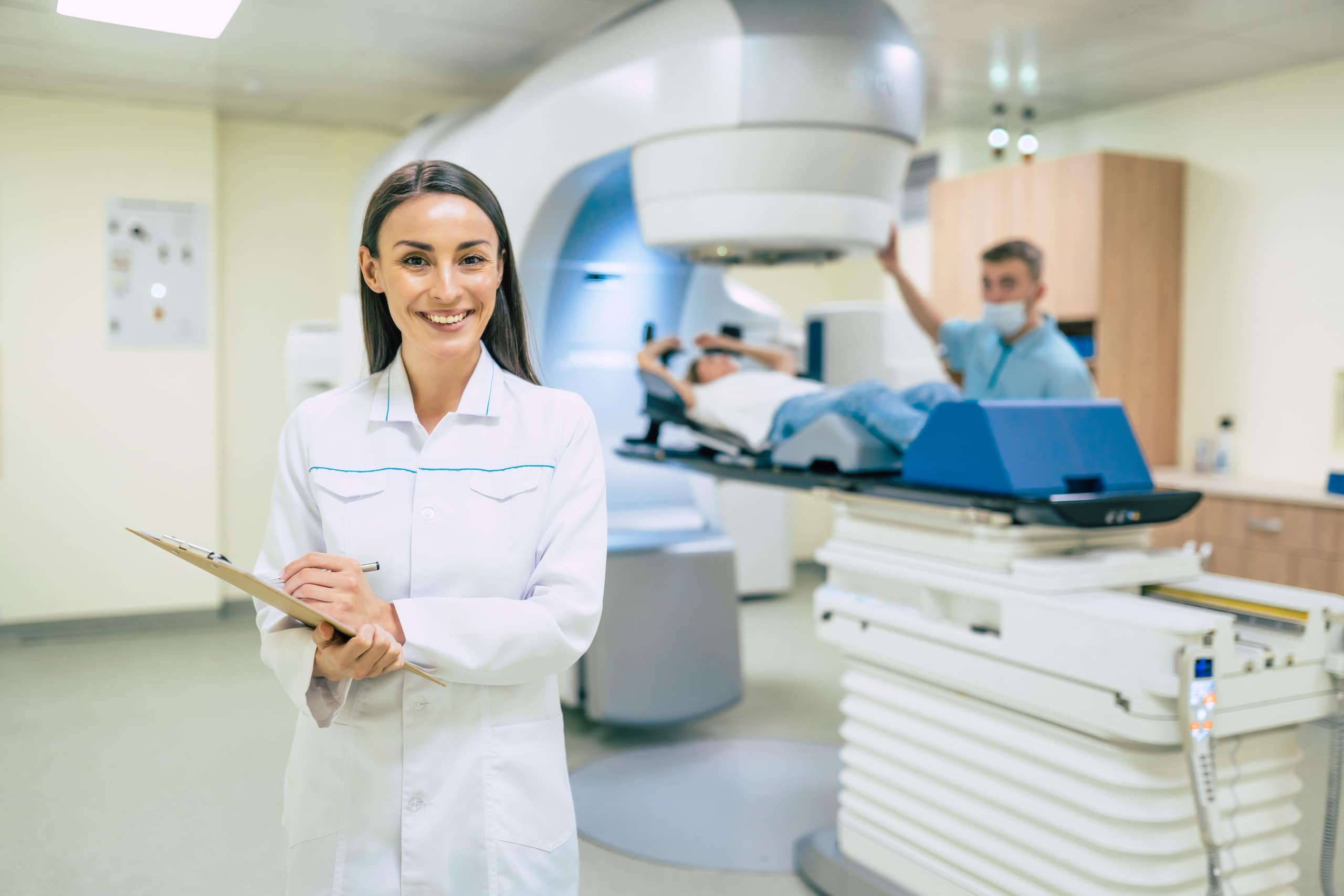 Smiling Radiologic Technologist standing with a clipboard