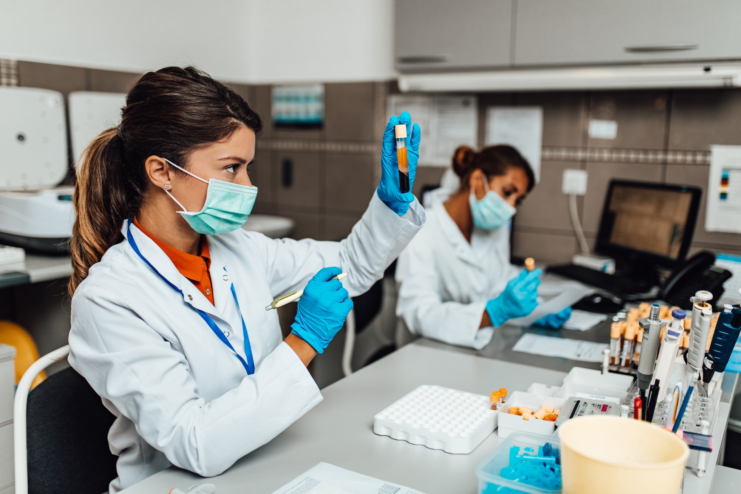 Female laboratory scientists looking at samples