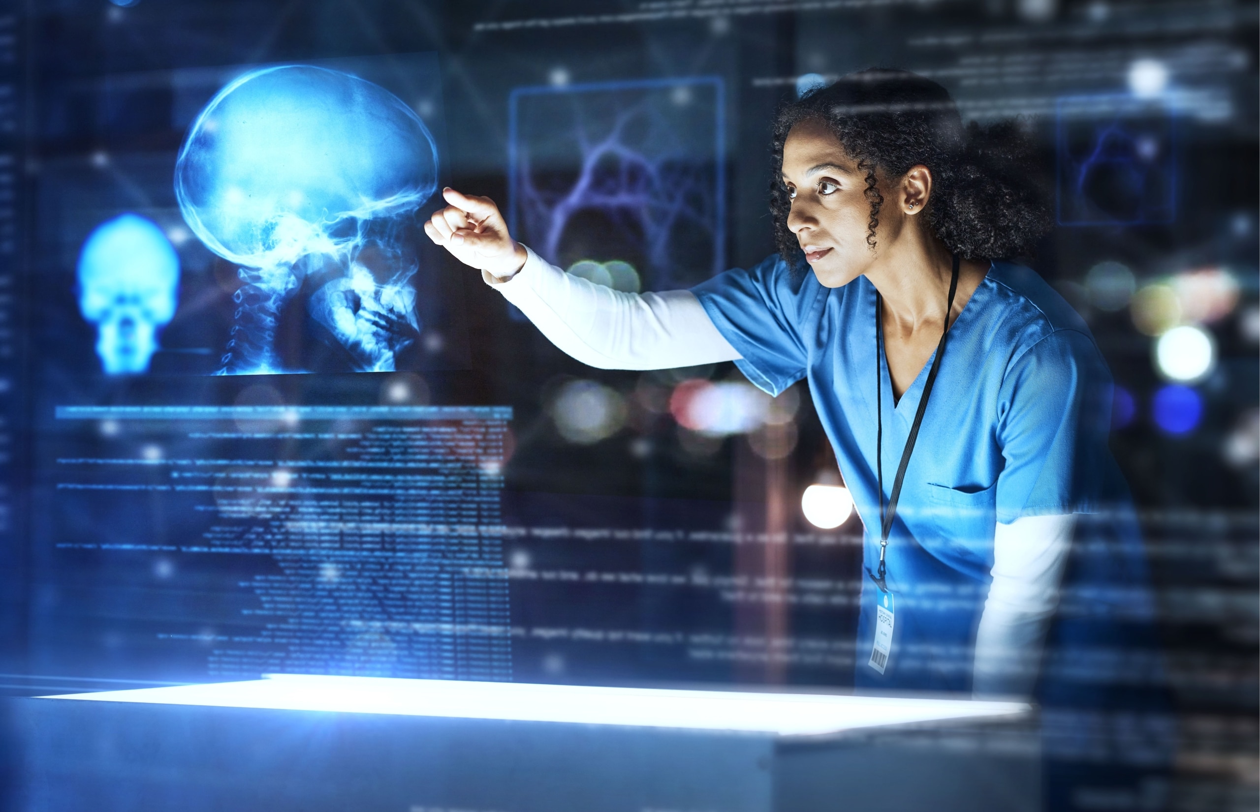 African-American nurse touching an AI projection of patient scans