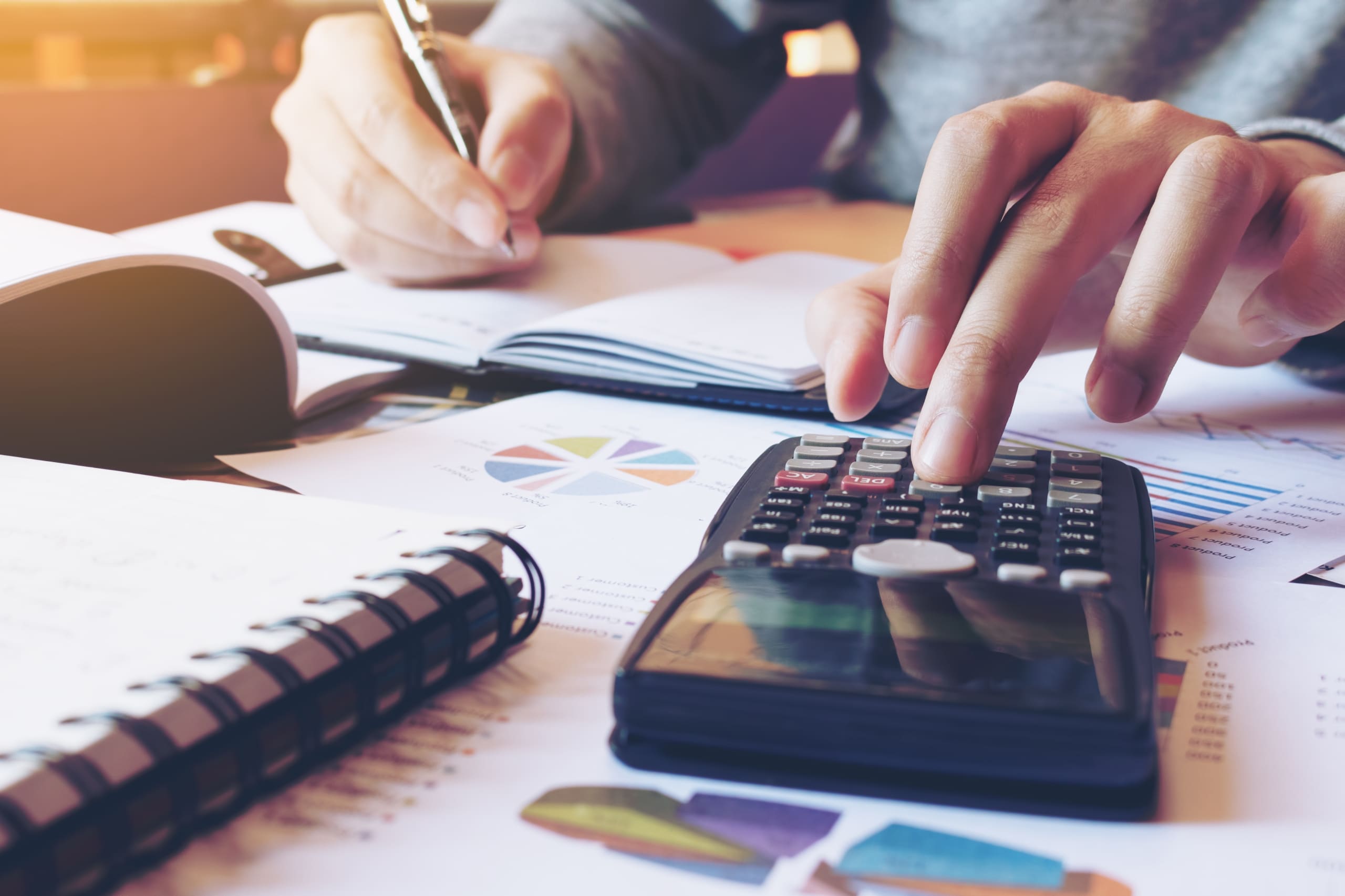 Close up of a man using a calculator and managing finances