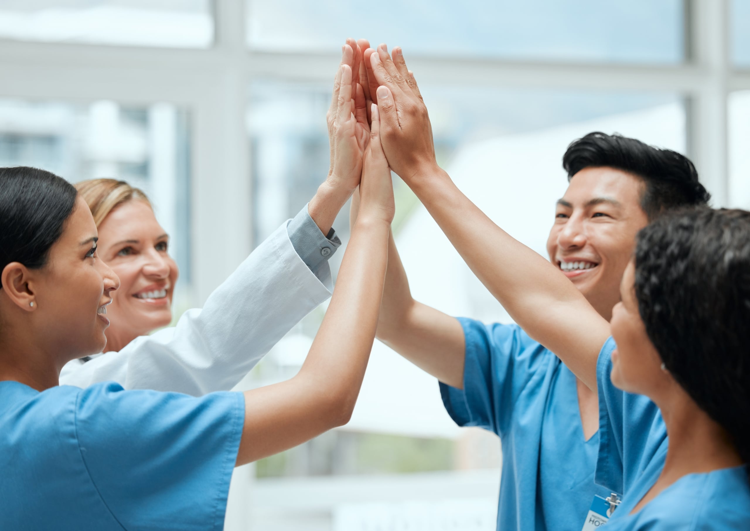 Happy medical professionals giving each other high fives