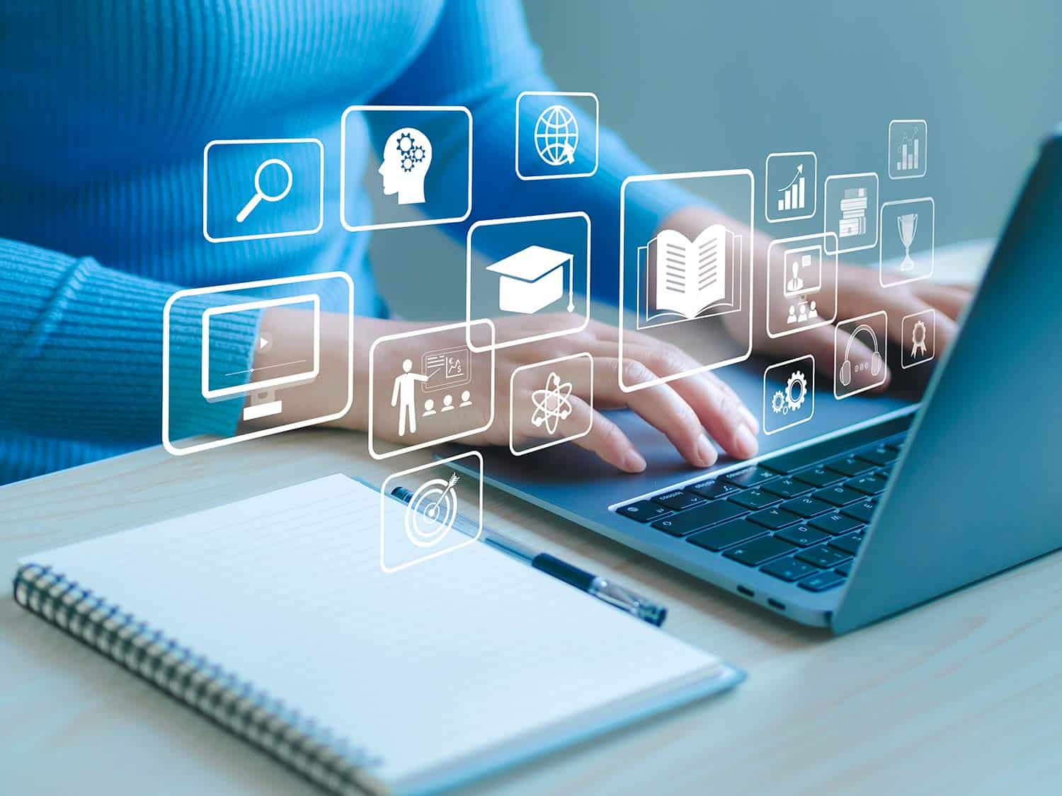 Close up of a woman using a laptop with virtual symbols